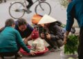 People gathered around a child in a basket at market