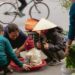 People gathered around a child in a basket at market