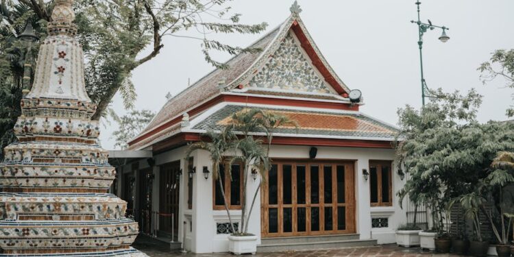 Explore the detailed architecture of Wat Pho Temple in Bangkok, Thailand, surrounded by lush greenery.