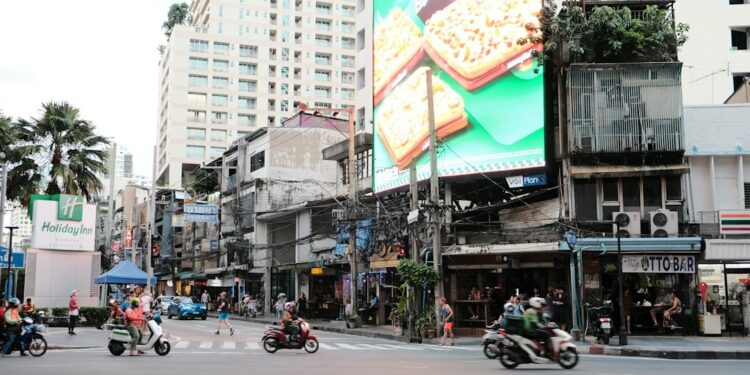 a city street filled with lots of traffic and tall buildings
