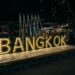 a sign that says bangkok lit up at night