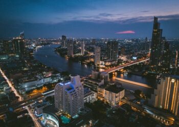 aerial photography of buildings near body of water during night