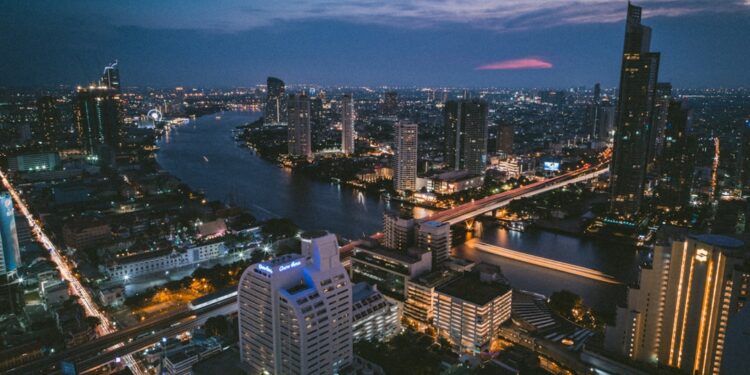 aerial photography of buildings near body of water during night