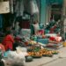Street vendor selling fruits and textiles