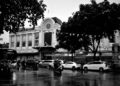 Monochrome street scene with building and cars