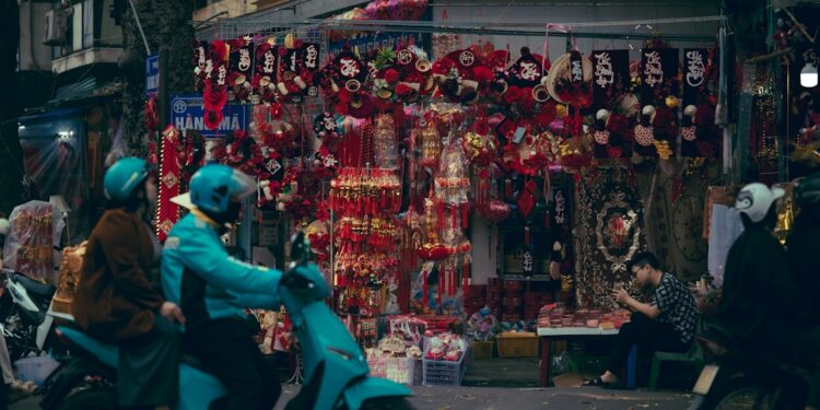 Street vendor selling red decorations and trinkets.
