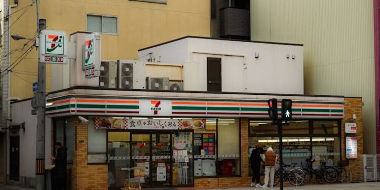 Candid street photo of a 7-Eleven convenience store in Japan.