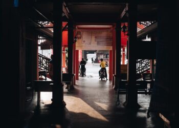 Shadowy market passageway with people in Terengganu, Malaysia.