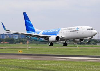 Garuda Indonesia plane taking off from a runway, showcasing modern aviation.