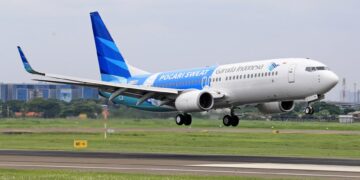 Garuda Indonesia plane taking off from a runway, showcasing modern aviation.