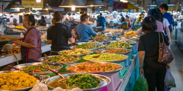 Explore the bustling atmosphere of a Bangkok street market with colorful Thai cuisine.