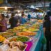 Explore the bustling atmosphere of a Bangkok street market with colorful Thai cuisine.
