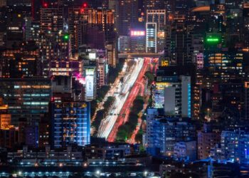 A breathtaking aerial view of Taipei at night showcasing bustling streets and illuminated skyscrapers.