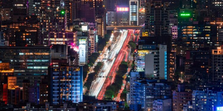 A breathtaking aerial view of Taipei at night showcasing bustling streets and illuminated skyscrapers.