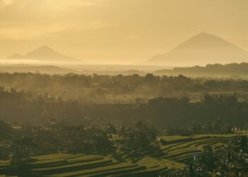 Stunning sunrise view of Bali's rice terraces and mountains, capturing Indonesia's natural beauty.