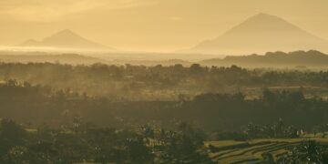 Stunning sunrise view of Bali's rice terraces and mountains, capturing Indonesia's natural beauty.