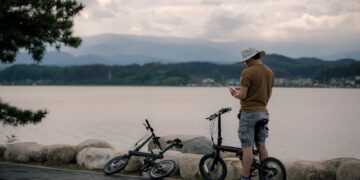 Man on bike enjoys serene view of Gyeongpo Lake, South Korea.