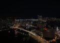 A stunning view of Busan skyline at night with Gwangan Bridge illuminating the cityscape.