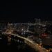 A stunning view of Busan skyline at night with Gwangan Bridge illuminating the cityscape.