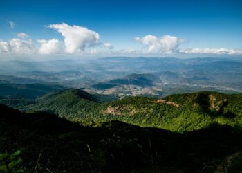 Expansive view of lush green mountains and clouds in Chiang Mai, Thailand.