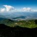 Expansive view of lush green mountains and clouds in Chiang Mai, Thailand.