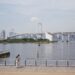 A serene day view of Rainbow Bridge and Tokyo skyline from Minato City waterfront.