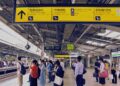 Commuters at a bustling train station in Tokyo, Japan, waiting for their train.