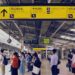 Commuters at a bustling train station in Tokyo, Japan, waiting for their train.