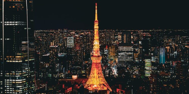 Stunning nighttime view of the Tokyo Tower glowing in the vibrant Tokyo skyline, Japan.