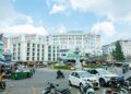 Vibrant street scene in Đà Lạt, Vietnam, showcasing hotels, traffic, and city life under a clear sky.
