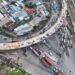 Aerial view of Ho Chi Minh City showcasing busy traffic around ongoing bridge construction.