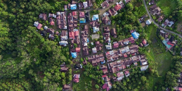 Stunning aerial photography of a village surrounded by lush greenery in Bengkulu, Indonesia.
