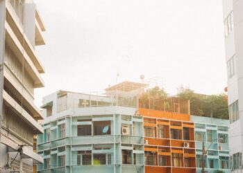 Vibrant cityscape of contemporary architecture in Bangkok, showcasing colorful residential buildings.