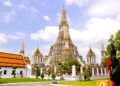 Beautiful architectural view of Wat Arun temple against blue sky in Bangkok, Thailand.