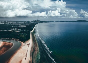 Stunning aerial view of Balok Beach in Pahang, Malaysia with coastal and cloud formations.