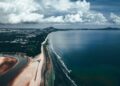Stunning aerial view of Balok Beach in Pahang, Malaysia with coastal and cloud formations.
