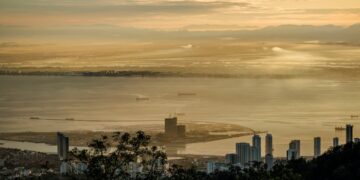 Stunning sunrise view over Penang from Bukit Bendera, Malaysia featuring skyscrapers and the coastline.