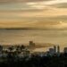Stunning sunrise view over Penang from Bukit Bendera, Malaysia featuring skyscrapers and the coastline.