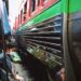 Experience the bustling Maeklong Railway Market in Bangkok with a train passing by closely.