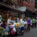 Vibrant street market scene in Asia with diverse vendors selling fresh produce.